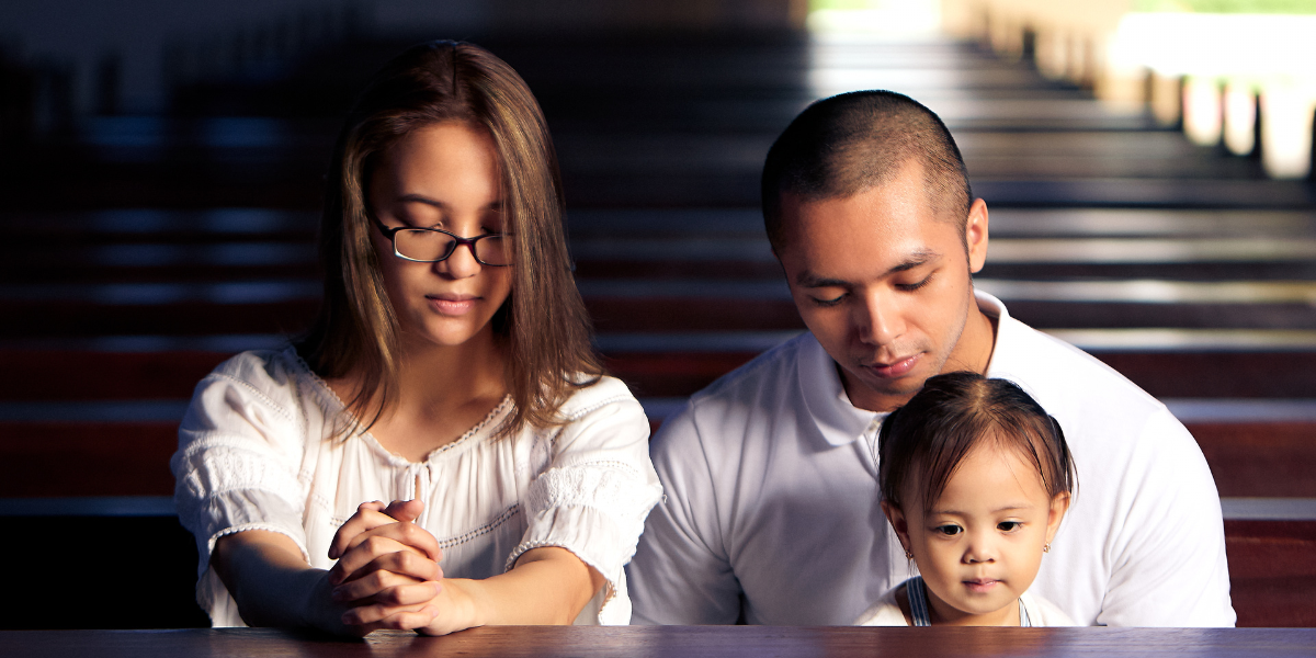 A family sitting in pews in church