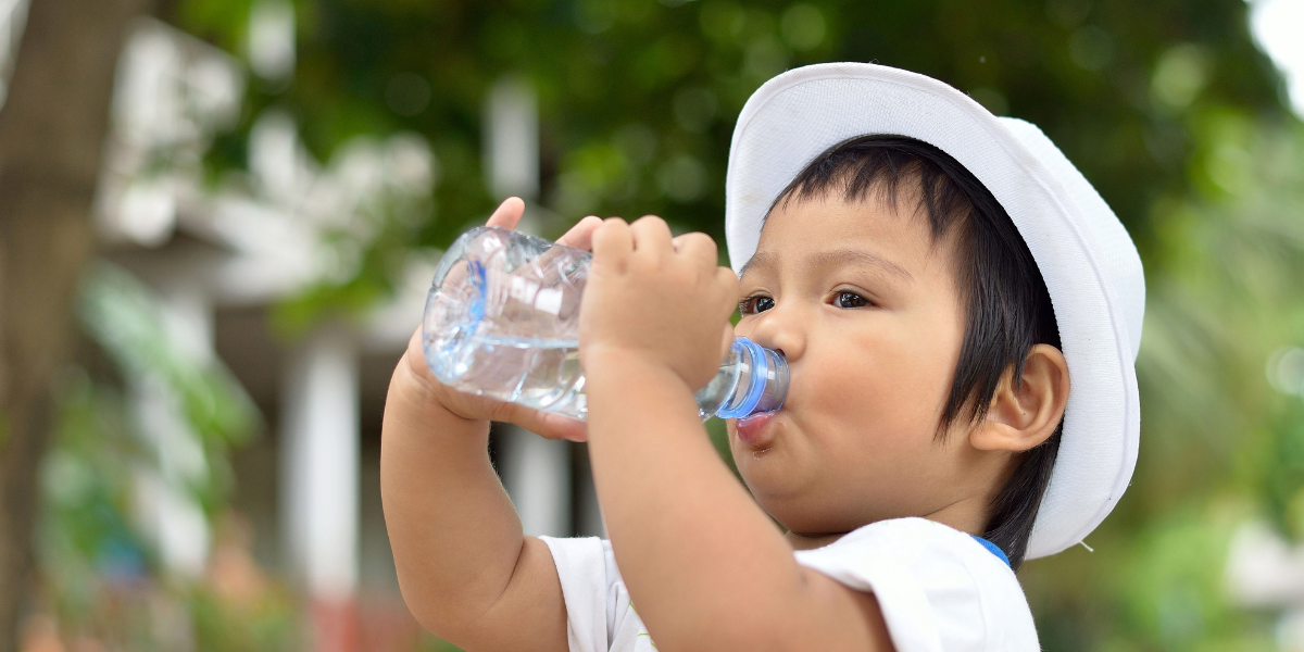 A young boy drinking water